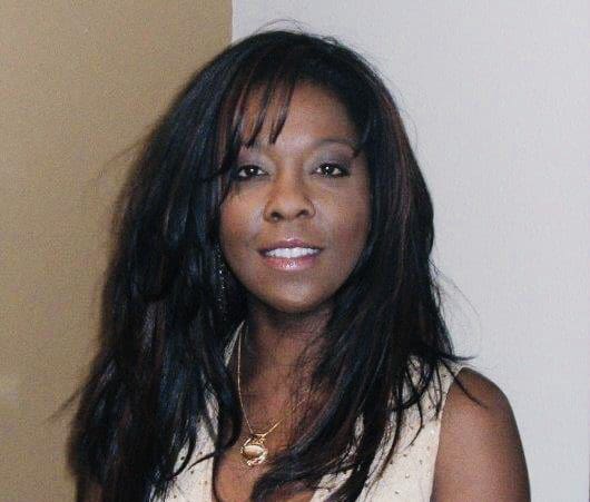 Portrait of a smiling woman with long black hair.